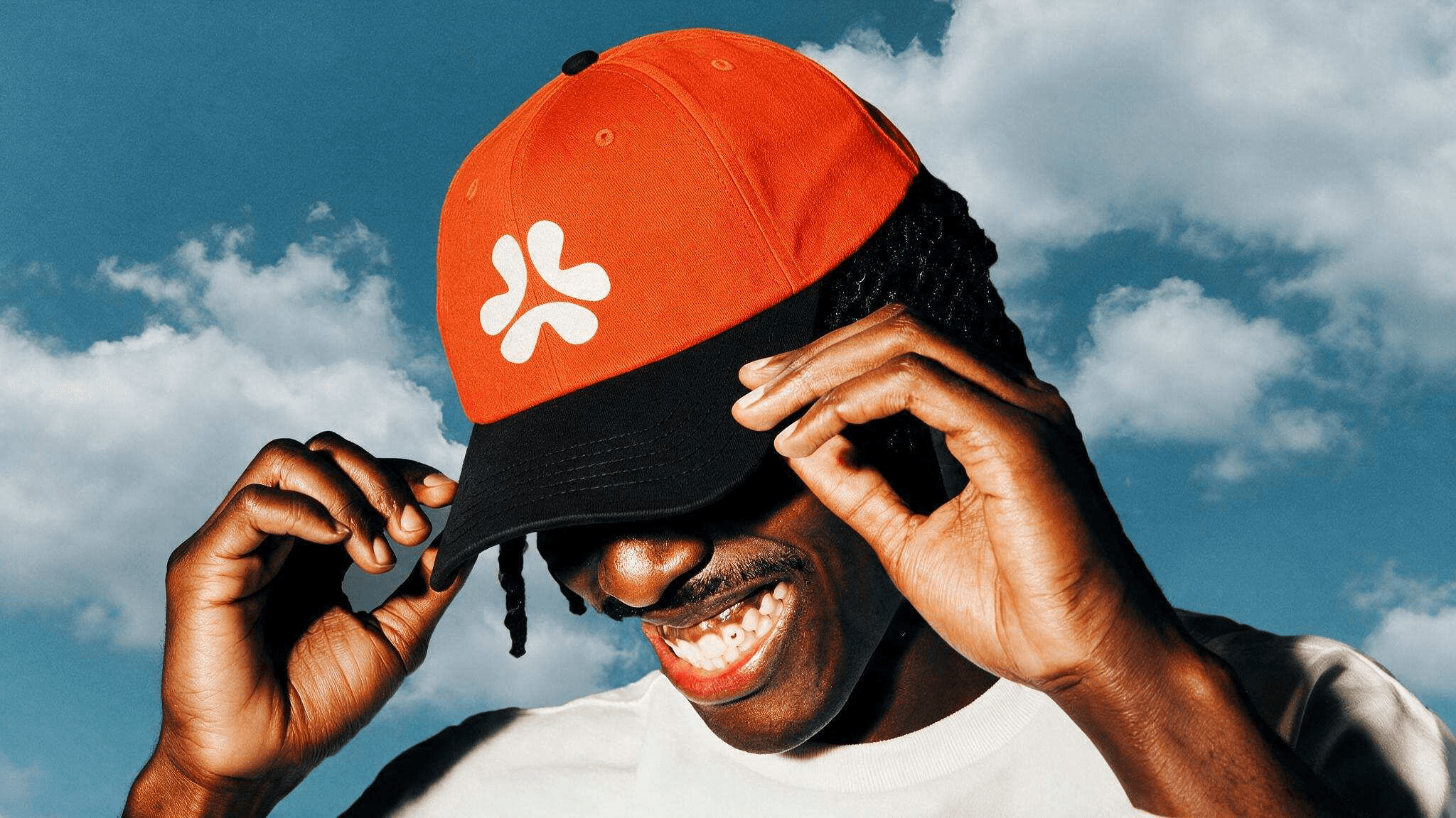 Someone wearing the AkuDozie cap against an open sky